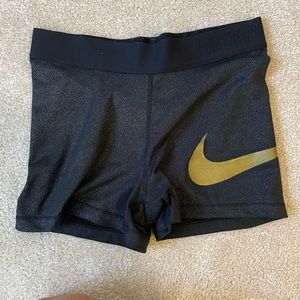 Womens small Nike pros with gold symbol
